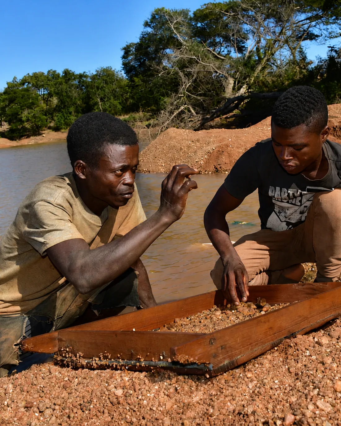 Miners washing gravel for rubies at a river near Montepuez
